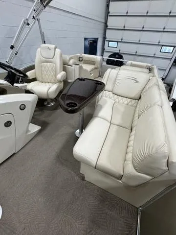 Slide: The Image of 2013 Bennington 2575 R boat interior with plush seating and modern dashboard. - 34
