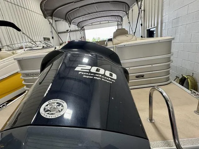 Slide: The Image of 2013 Bennington 2575 R pontoon boat with 200 horsepower engine in storage. - 35
