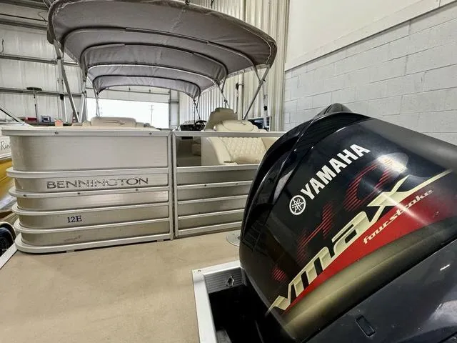 Slide: The Image of 2013 Bennington 2575 R pontoon boat with Yamaha VMAX engine in a storage facility. - 36