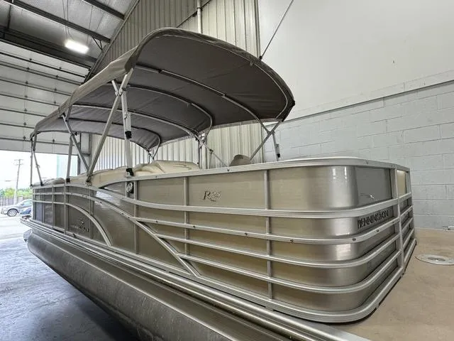 Slide: The Image of 2013 Bennington 2575 R pontoon boat in a warehouse setting. - 6