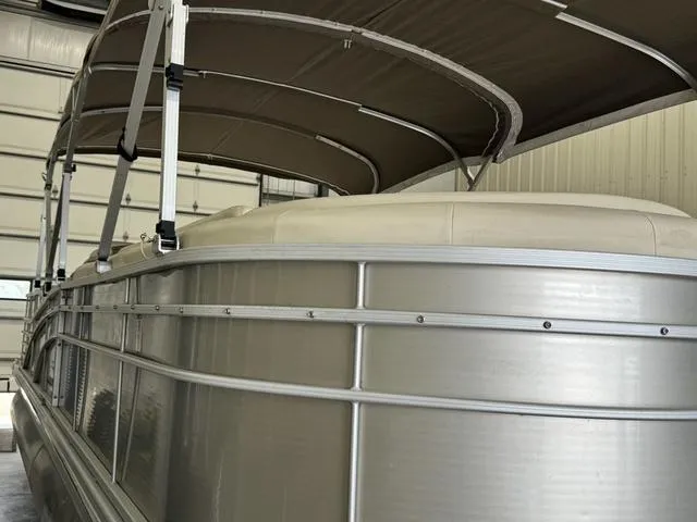 Slide: The Image of 2013 Bennington 2575 R pontoon boat with canopy in storage. - 7