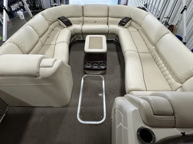 Slide: The Image of 2013 Bennington 2575 R pontoon boat with spacious beige seating and cup holders. - 8