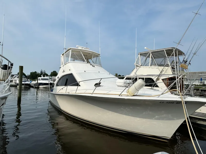 Slide: The Image of 1993 Ocean Yachts 42 Super Sport docked at marina under clear sky. - 0