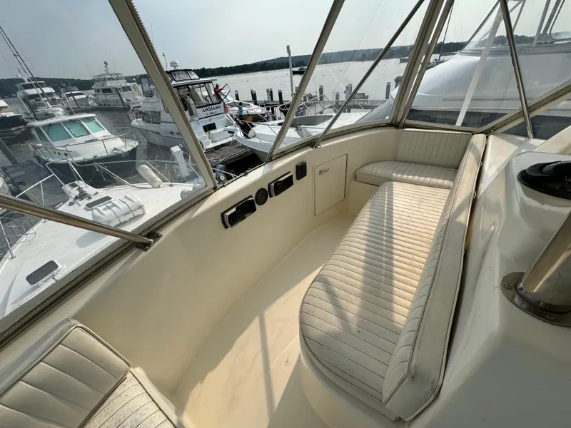 Slide: The Image of Cockpit view of 1993 Ocean Yachts 42 Super Sport at marina, featuring white seating. - 10