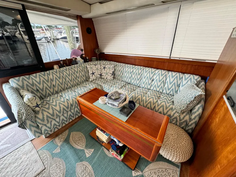 Slide: The Image of Cozy interior of 1993 Ocean Yachts 42 Super Sport with patterned seating and wooden table. - 12