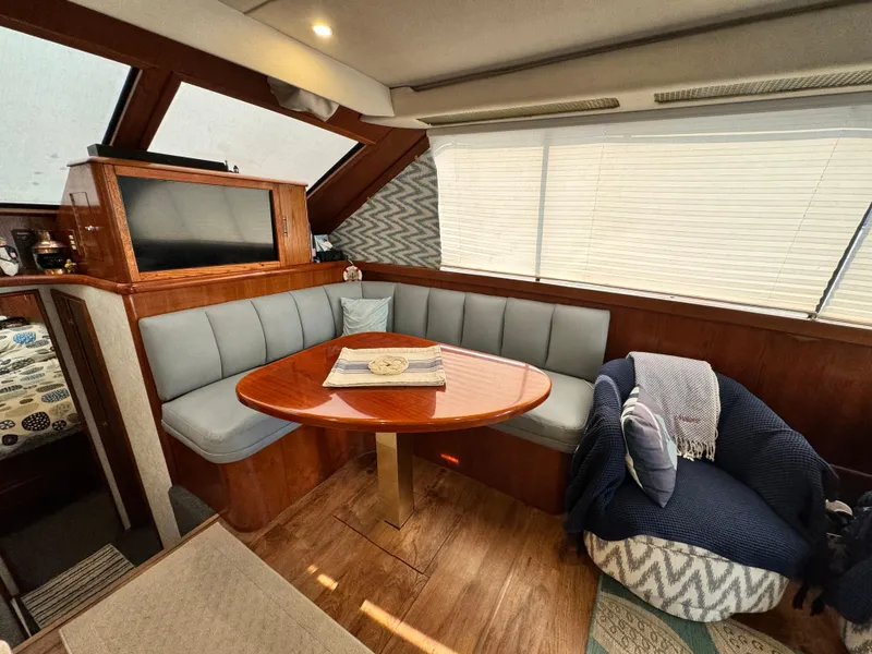 Slide: The Image of Interior of 1993 Ocean Yachts 42 Super Sport with cozy seating and wooden table. - 13