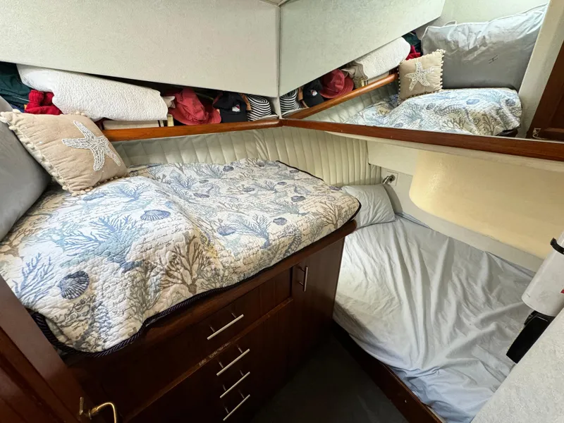 Slide: The Image of Cozy cabin interior of 1993 Ocean Yachts 42 Super Sport with nautical-themed bedding. - 19