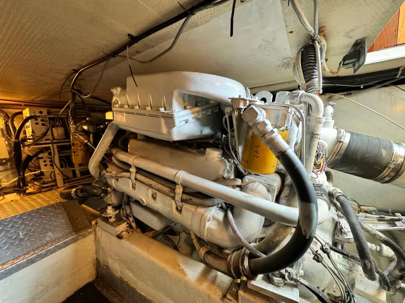 Slide: The Image of Engine room of a 1993 Ocean Yachts 42 Super Sport, showcasing detailed mechanical components. - 21