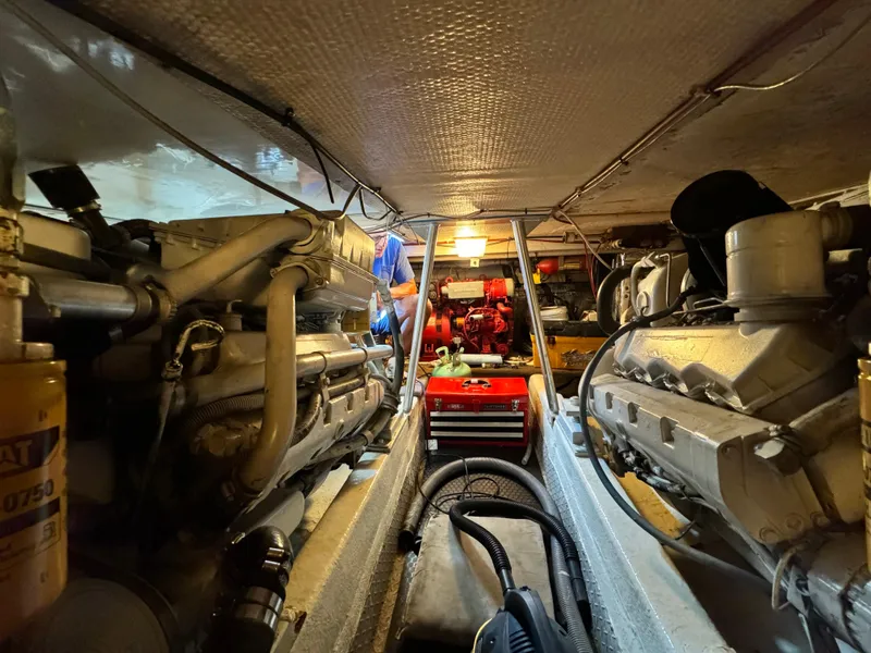 Slide: The Image of Engine room of 1993 Ocean Yachts 42 Super Sport, showcasing dual engines and maintenance area. - 25