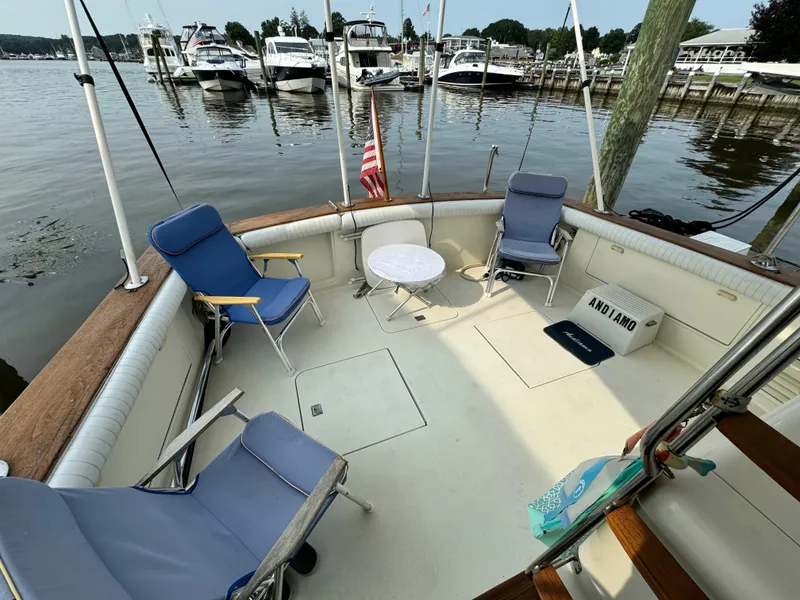 Slide: The Image of 1993 Ocean Yachts 42 Super Sport deck with chairs and table, docked at marina. - 3