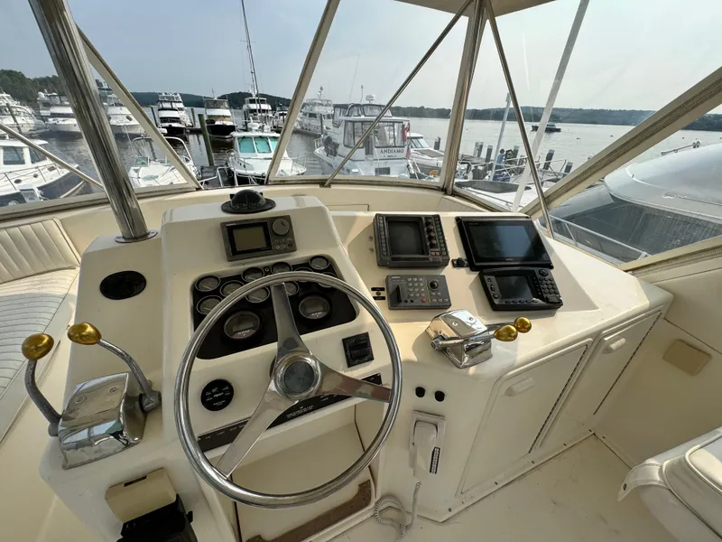 Slide: The Image of Helm of 1993 Ocean Yachts 42 Super Sport with navigational instruments, overlooking marina. - 7