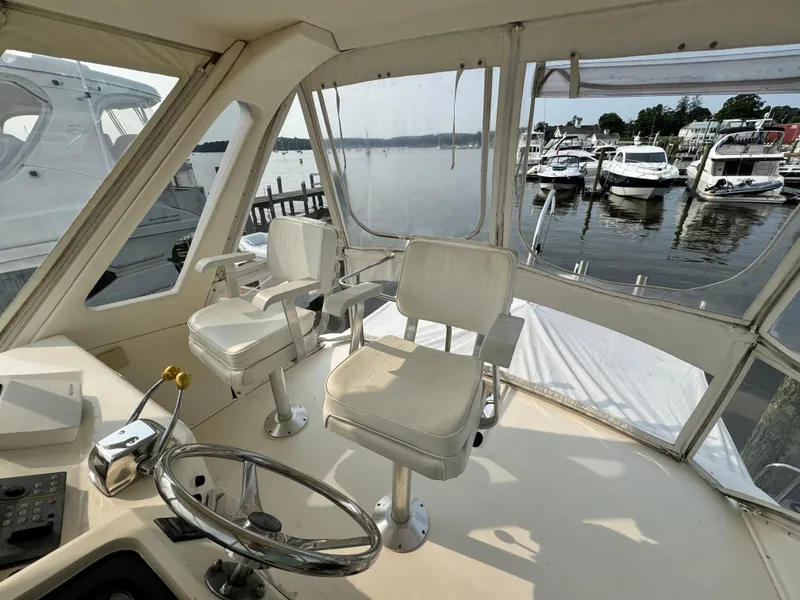 Slide: The Image of Interior view of 1993 Ocean Yachts 42 Super Sport with helm and marina backdrop. - 9