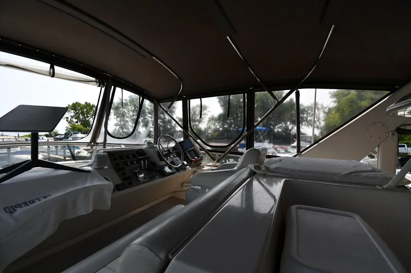 Slide: The Image of 1997 Carver 405 Motor Yacht interior with helm and seating area. - 17