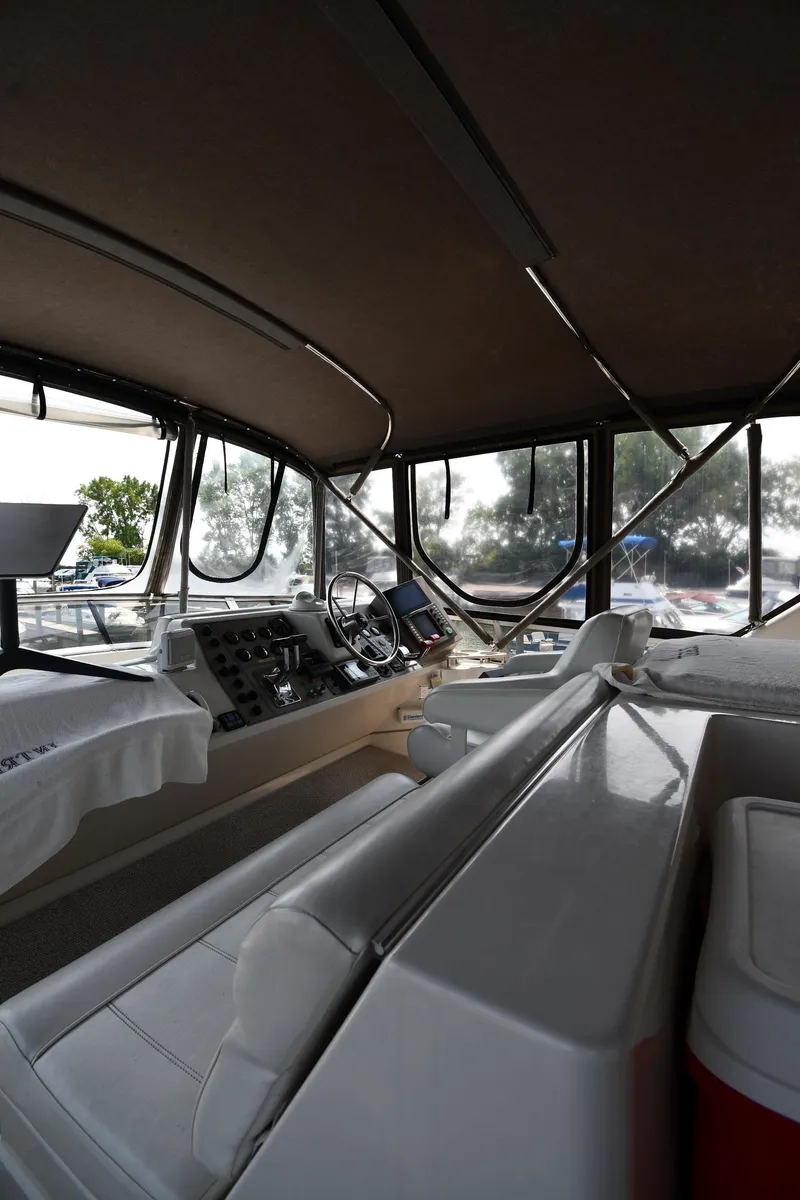 Slide: The Image of 1997 Carver 405 Motor Yacht interior with helm and seating area. - 18