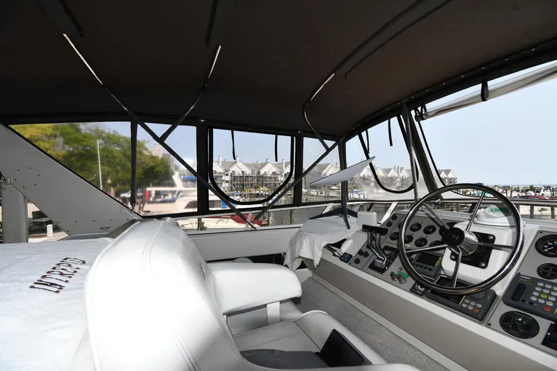 Slide: The Image of Interior view of 1997 Carver 405 Motor Yacht cockpit with steering wheel and controls. - 19