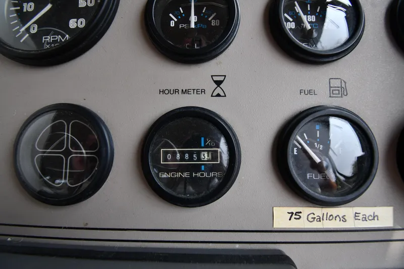 Slide: The Image of Dashboard gauges of a 1997 Carver 405 Motor Yacht, showing engine hours and fuel levels. - 24