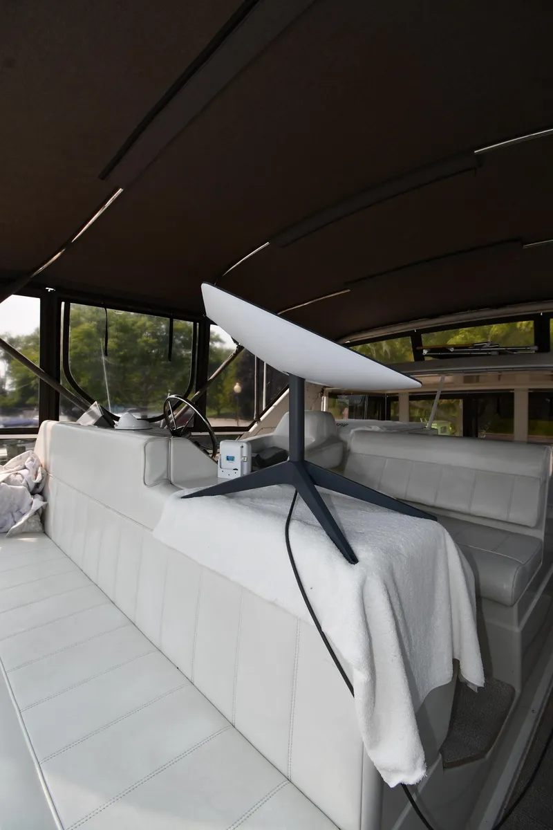 Slide: The Image of 1997 Carver 405 Motor Yacht interior with modern satellite dish setup. - 29