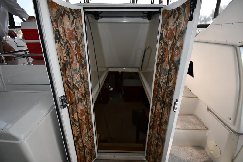 Slide: The Image of 1997 Carver 405 Motor Yacht interior entrance with patterned doors and stairs. - 31