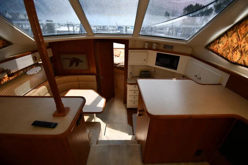 Slide: The Image of Interior of 1997 Carver 405 Motor Yacht with kitchen and seating area. - 32