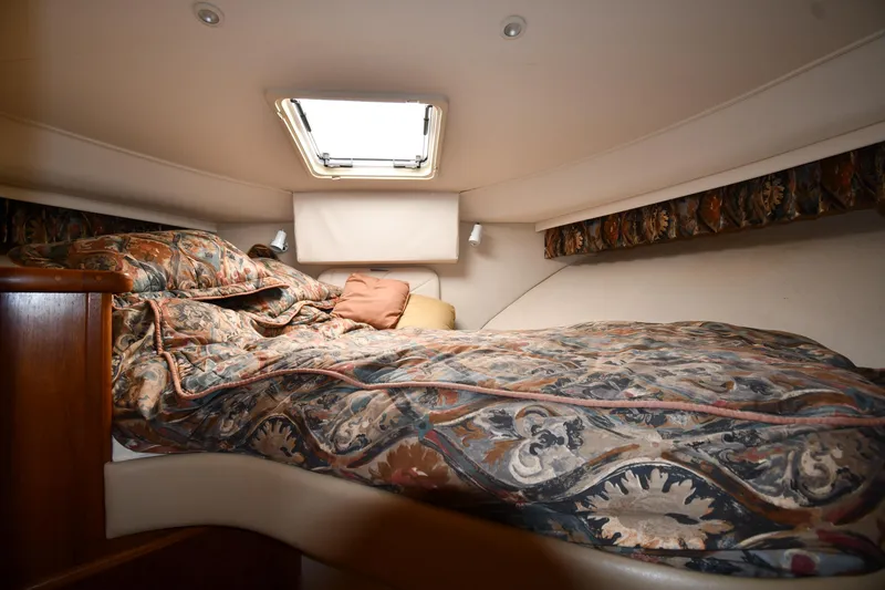 Slide: The Image of Cozy bedroom in 1997 Carver 405 Motor Yacht with patterned bedding and overhead window. - 34