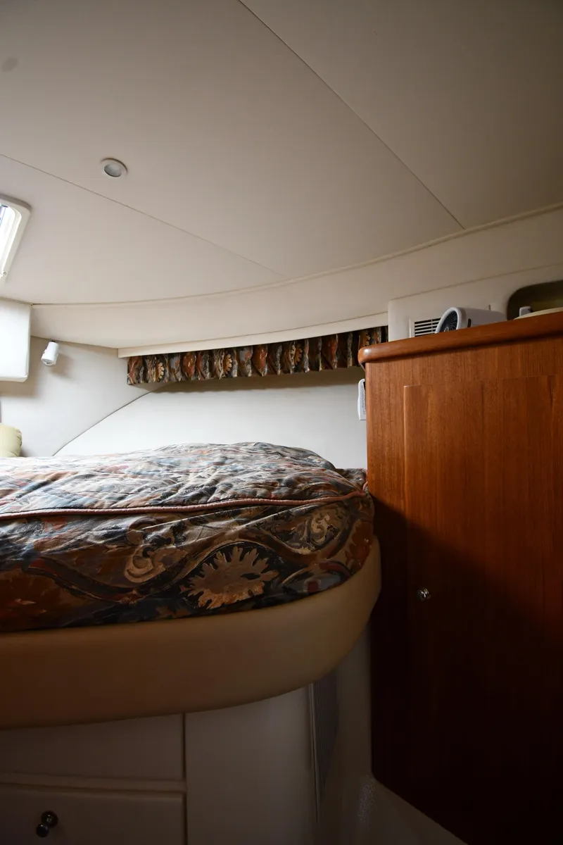 Slide: The Image of 1997 Carver 405 Motor Yacht interior with bed and wooden cabinet. - 35