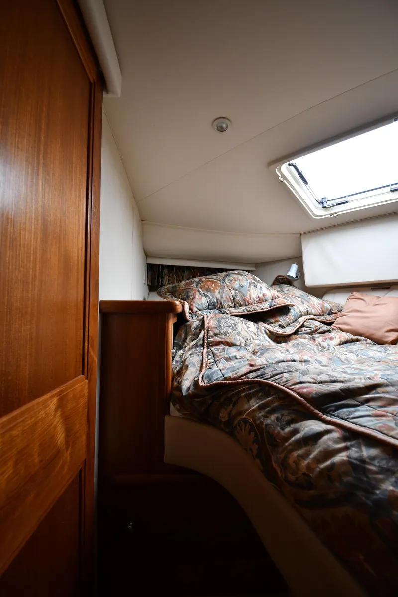 Slide: The Image of Cozy cabin interior of 1997 Carver 405 Motor Yacht with floral bedding. - 36