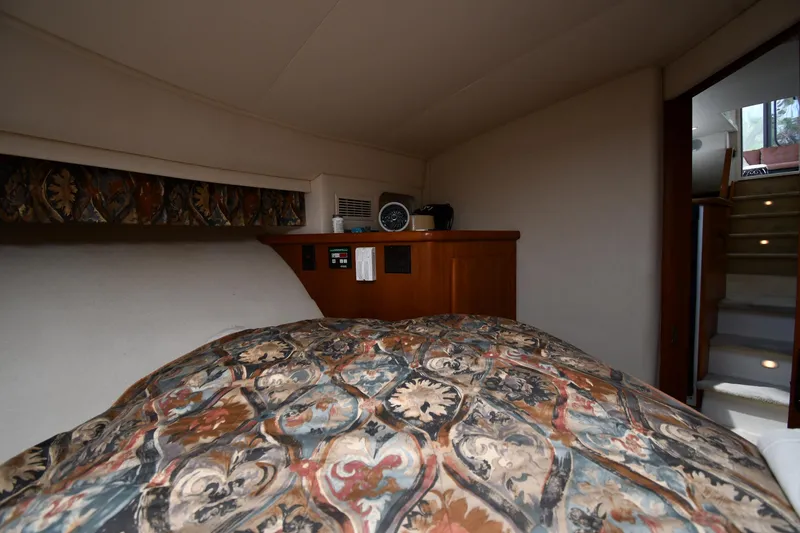 Slide: The Image of Interior cabin of 1997 Carver 405 Motor Yacht with patterned bedding. - 38