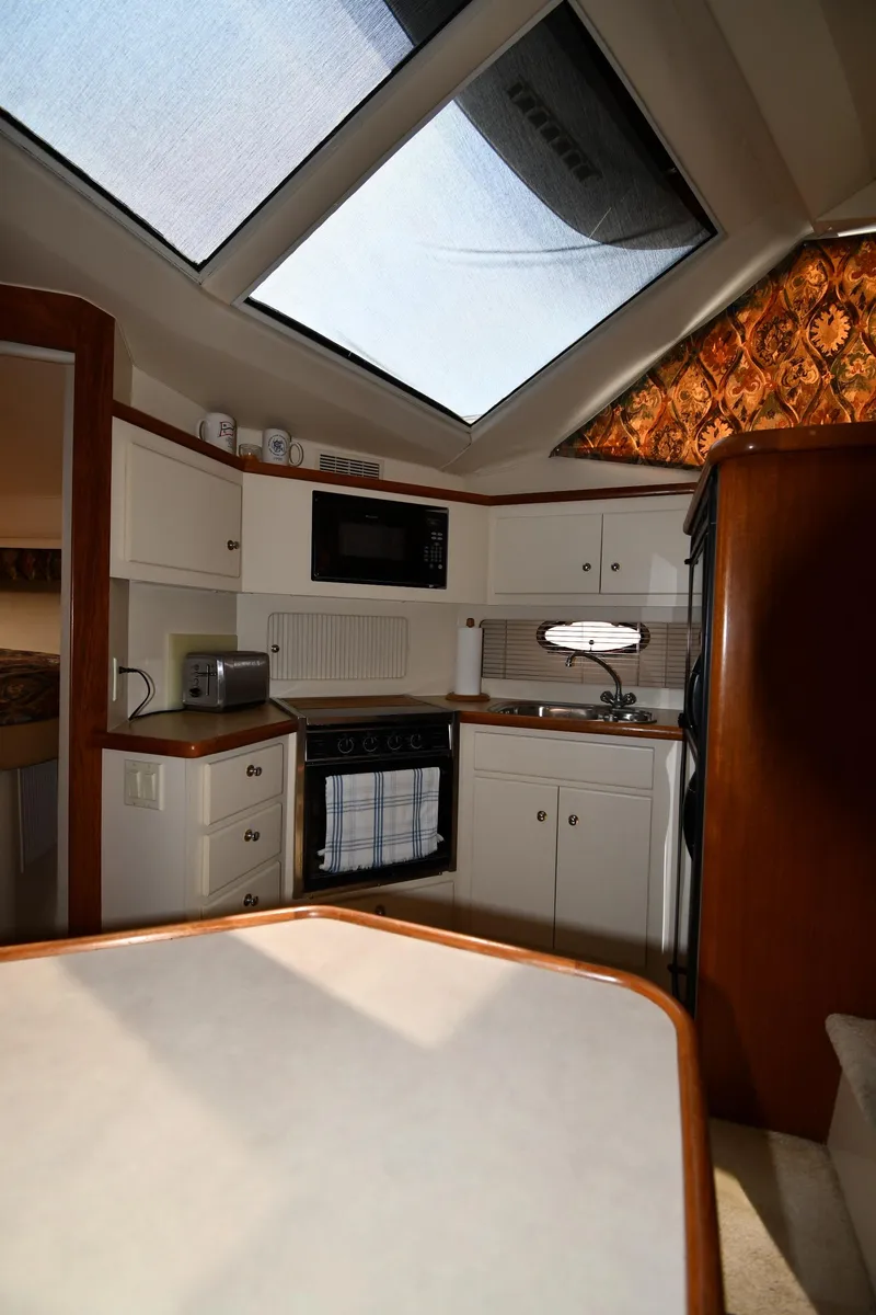 Slide: The Image of Interior of 1997 Carver 405 Motor Yacht kitchen with skylight and modern appliances. - 42