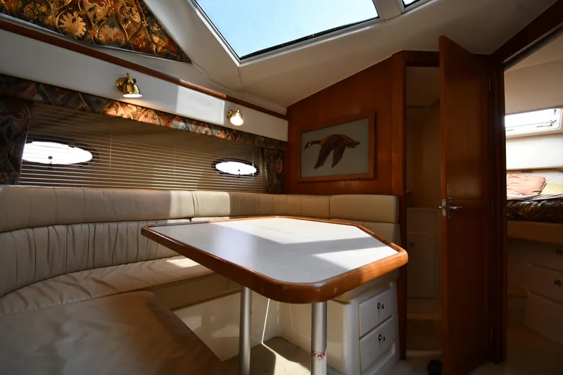 Slide: The Image of Interior of 1997 Carver 405 Motor Yacht with dining area and natural light. - 43