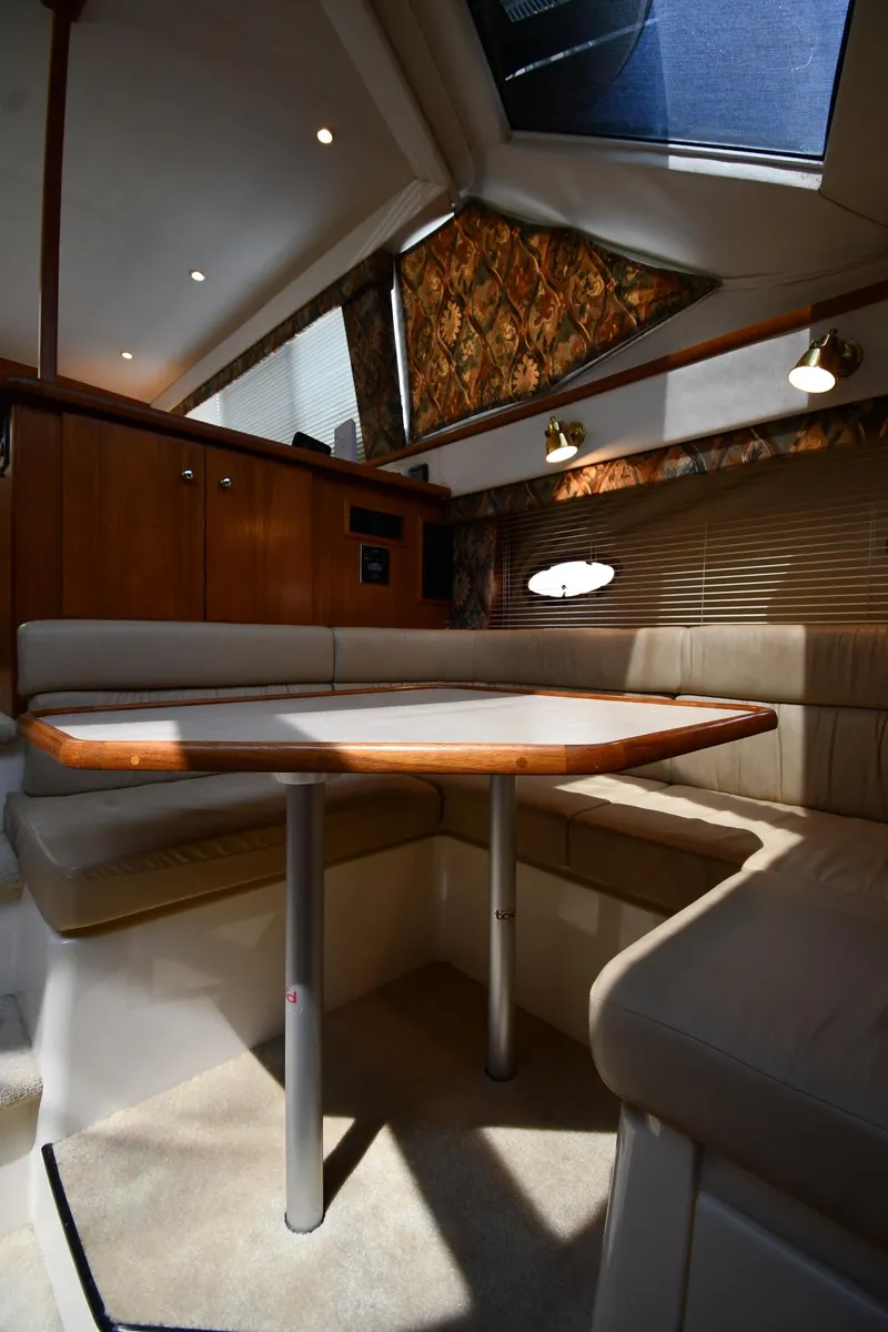 Slide: The Image of Interior of 1997 Carver 405 Motor Yacht with cozy dining area and skylight. - 46
