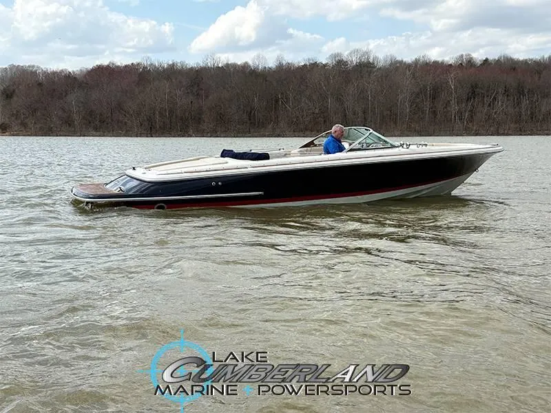 Slide: The Image of 2009 Chris-Craft Launch 25 Heritage Edition boat on a lake with wooded shoreline. - 2