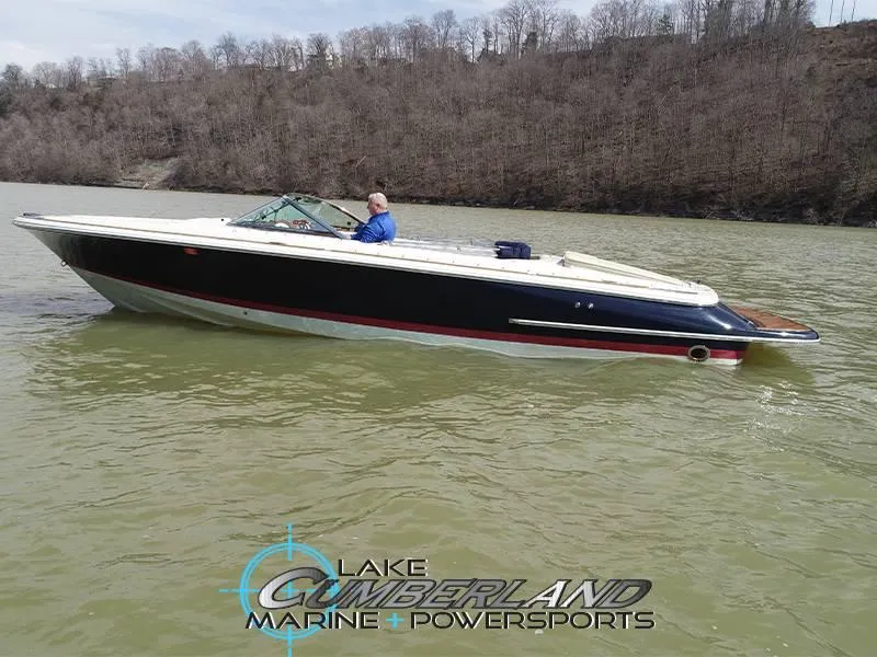 Slide: The Image of 2009 Chris-Craft Launch 25 Heritage Edition boat on a lake, with wooded shoreline background. - 3