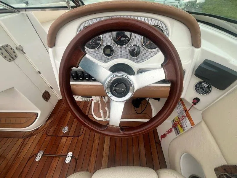 Slide: The Image of 2009 Chris-Craft Launch 25 Heritage Ed dashboard with wooden steering wheel and gauges. - 47