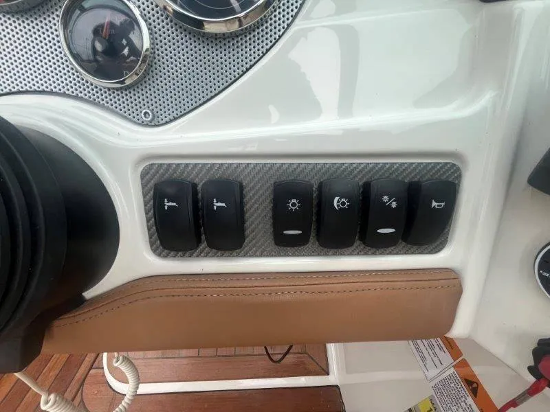Slide: The Image of Dashboard controls of a 2009 Chris-Craft Launch 25 Heritage Edition boat. - 54