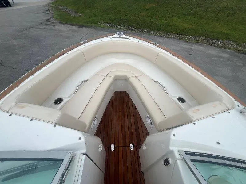 Slide: The Image of 2009 Chris-Craft Launch 25 Heritage Edition boat interior with white seating and wooden deck. - 56
