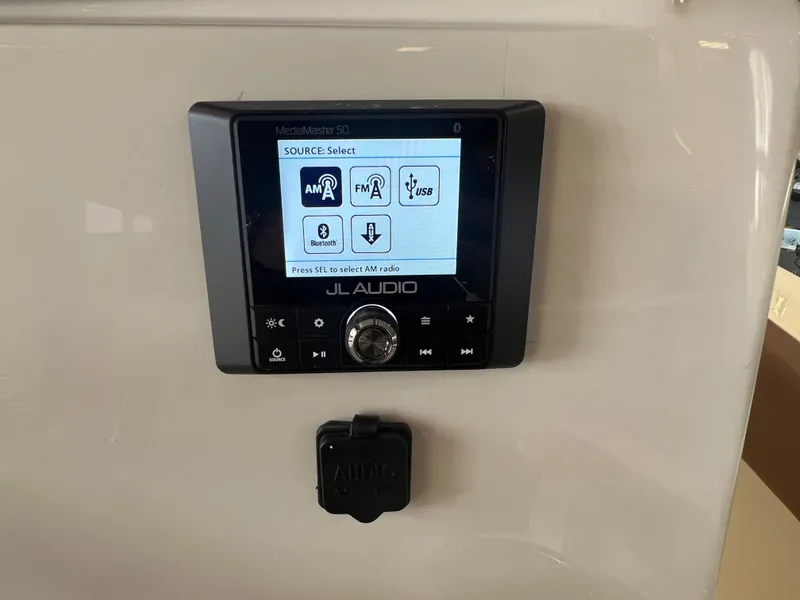 Slide: The Image of JL Audio system on 2024 Pioneer 202 Islander boat dashboard. - 10