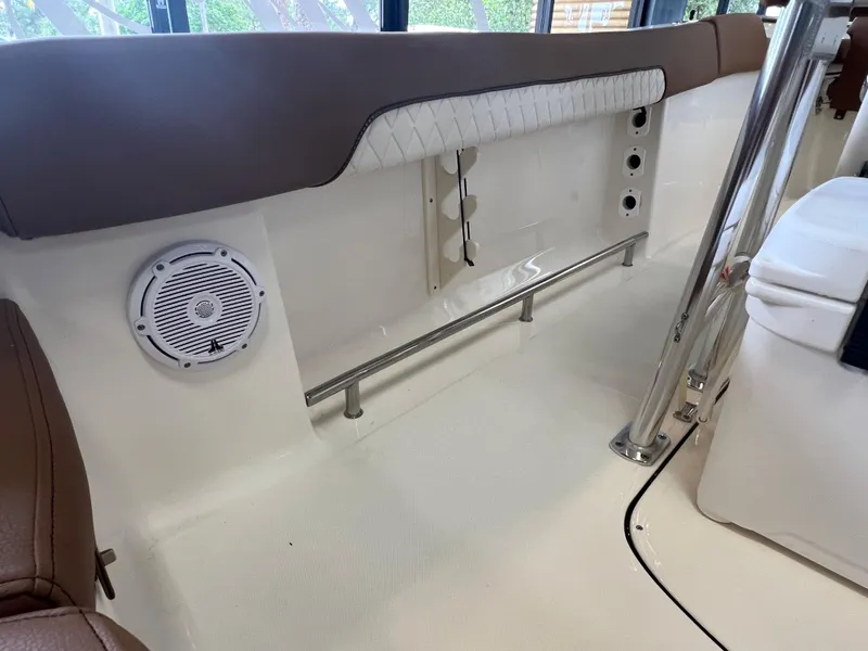 Slide: The Image of 2024 Pioneer 202 Islander boat interior with speaker and seating area. - 12
