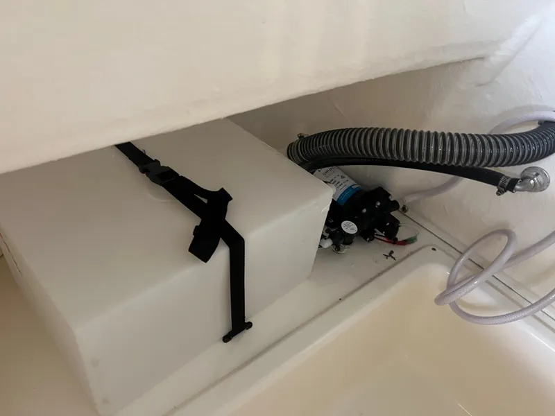 Slide: The Image of 2024 Pioneer 202 Islander boat storage compartment with water tank and pump system. - 16