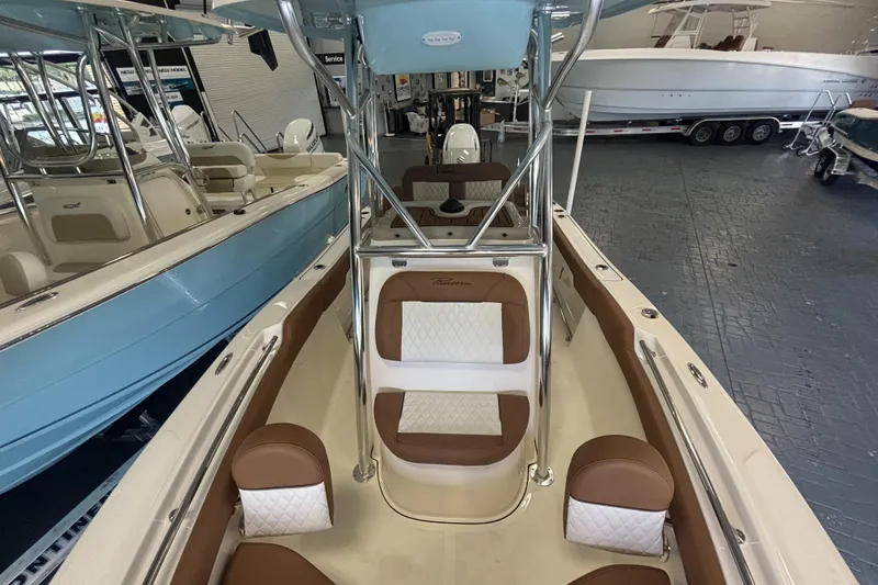 Slide: The Image of 2024 Pioneer 202 Islander boat interior with brown and white seating, showroom display. - 5