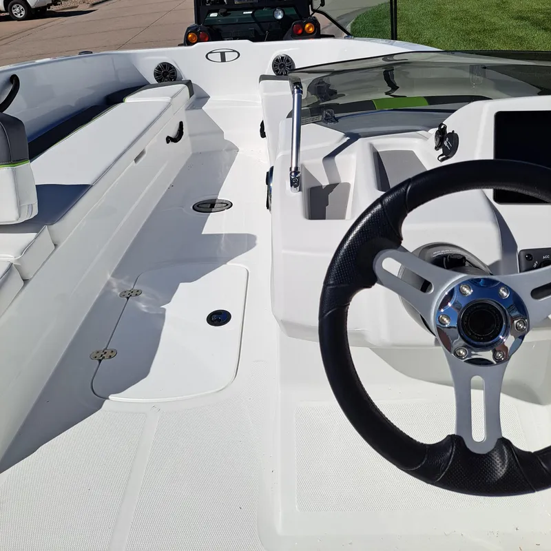 Slide: The Image of 2024 Tahoe T18 boat interior with steering wheel and seating area. - 4