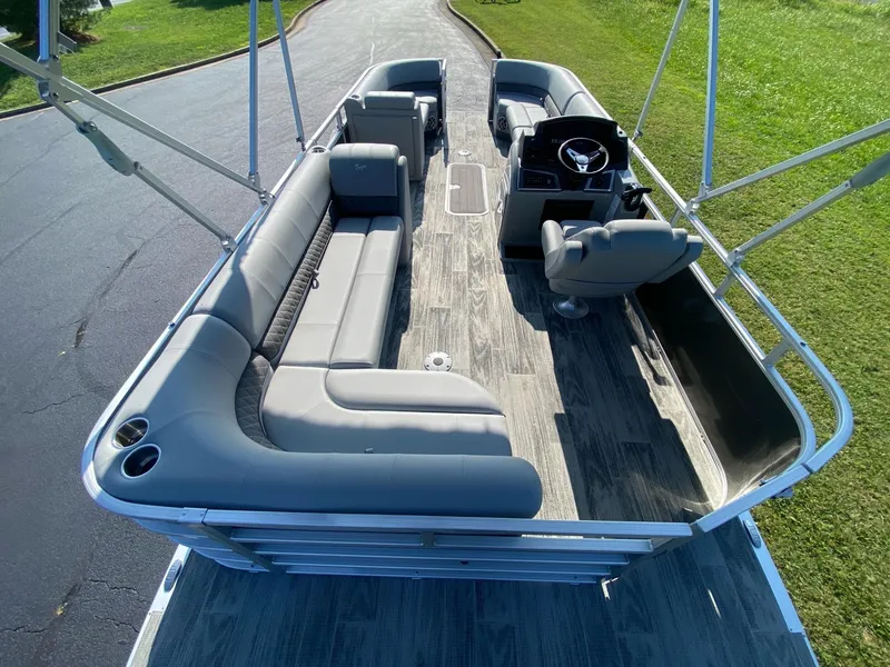Slide: The Image of 2024 Ranger Reata 223C pontoon boat with spacious seating and modern design. - 10