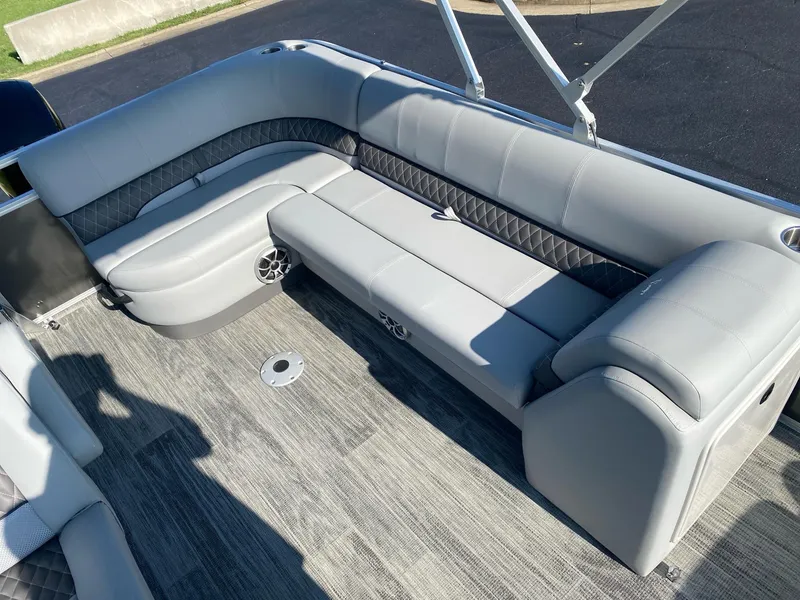 Slide: The Image of 2024 Ranger Reata 223C boat interior with gray seating and carpeted flooring. - 11