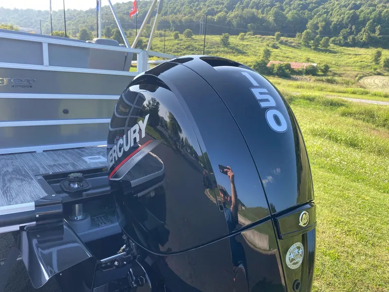 Slide: The Image of 2024 Ranger Reata 223C with Mercury 150 outboard engine in scenic landscape. - 5