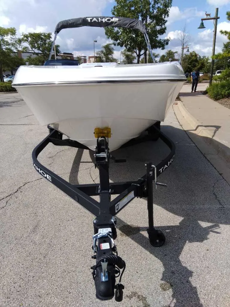 Slide: The Image of 2024 Tahoe T18 boat on trailer, parked on street, sunny day. - 1
