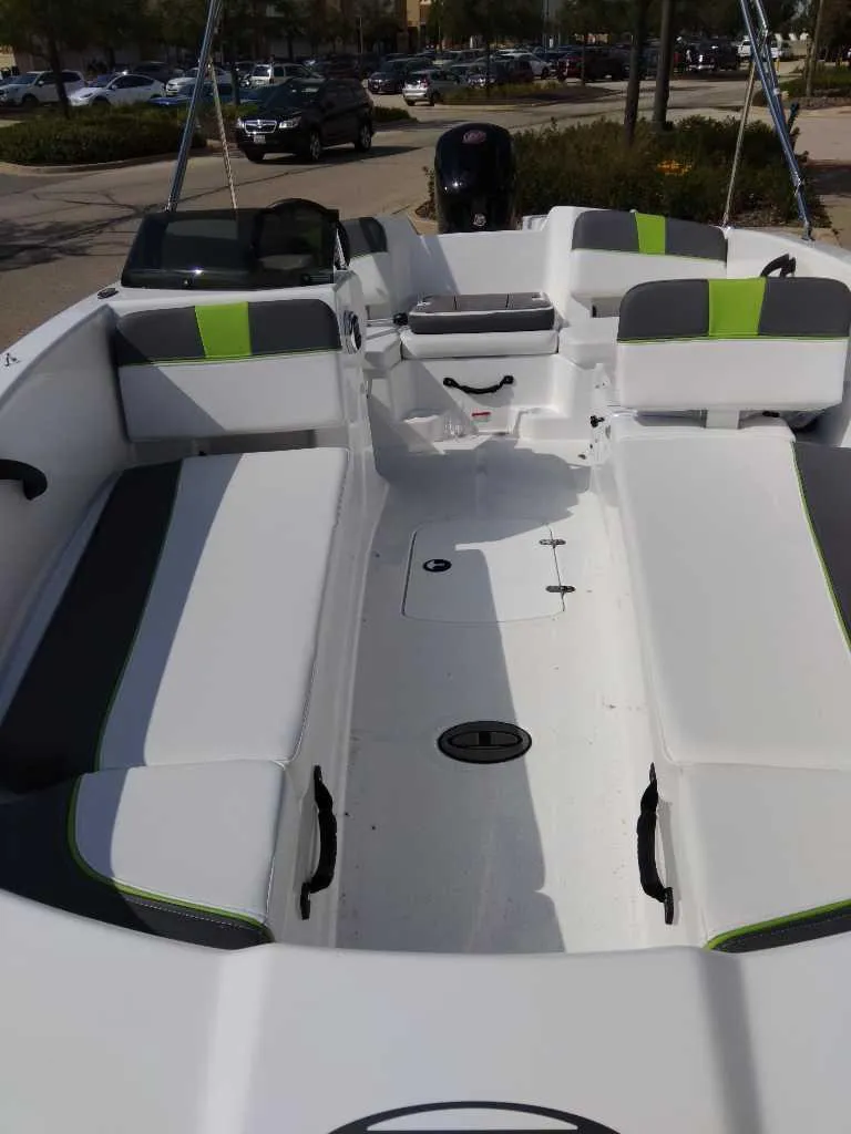Slide: The Image of 2024 Tahoe T18 boat interior with white and green seating. - 2
