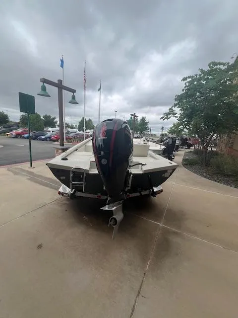 Slide: The Image of 2024 Ranger RB200 boat on trailer in front of store. - 2
