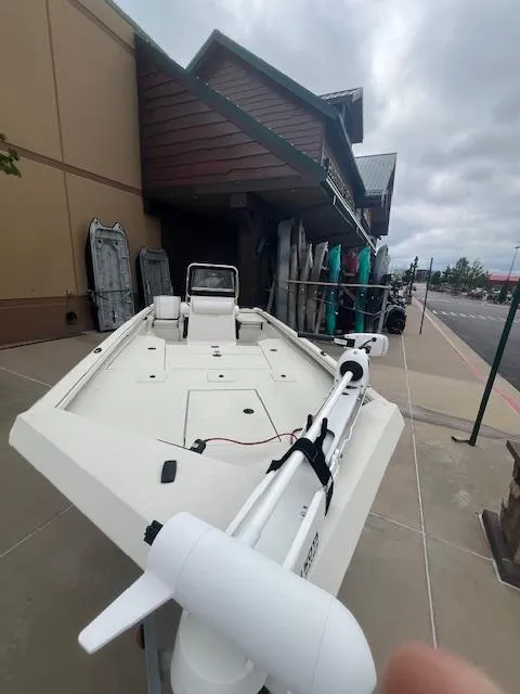 Slide: The Image of 2024 Ranger RB200 boat with console, parked outdoors under cloudy skies. - 5