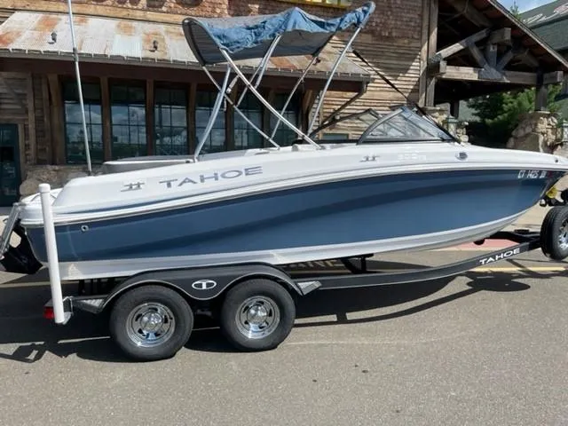 Slide: The Image of 2021 Tahoe TAH500TS boat on trailer, parked outdoors. - 1