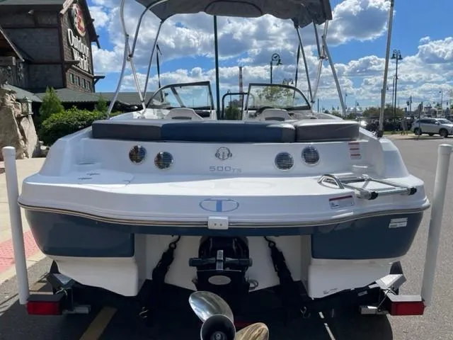 Slide: The Image of 2021 Tahoe TAH500TS boat parked outdoors under a cloudy sky. - 2