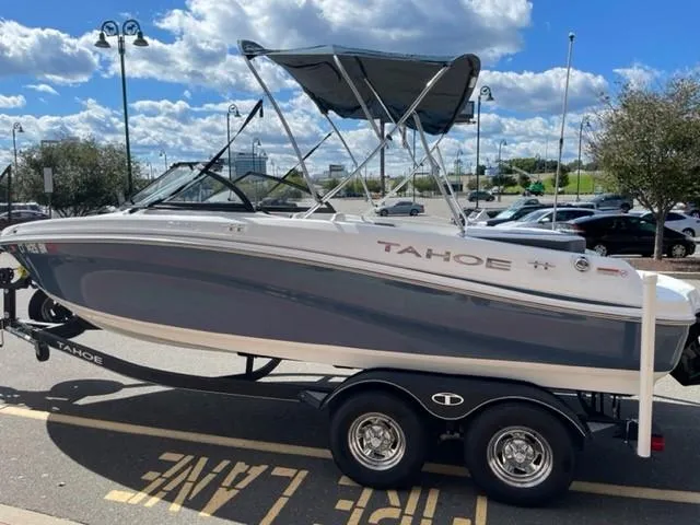 Slide: The Image of 2021 Tahoe TAH500TS boat on trailer, parked outdoors under a blue sky. - 3